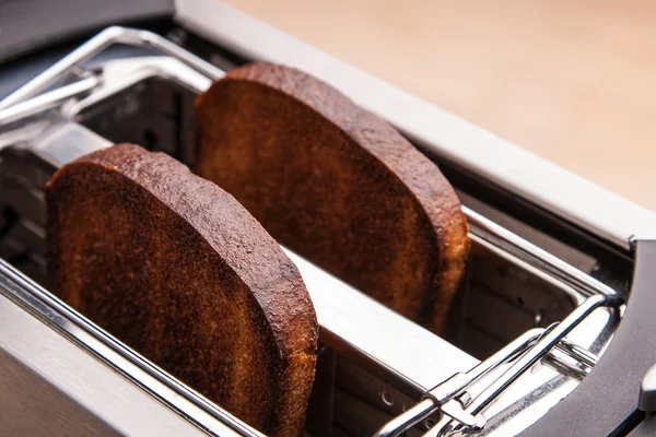 Two hot bread toast in toaster — Stock Photo, Image