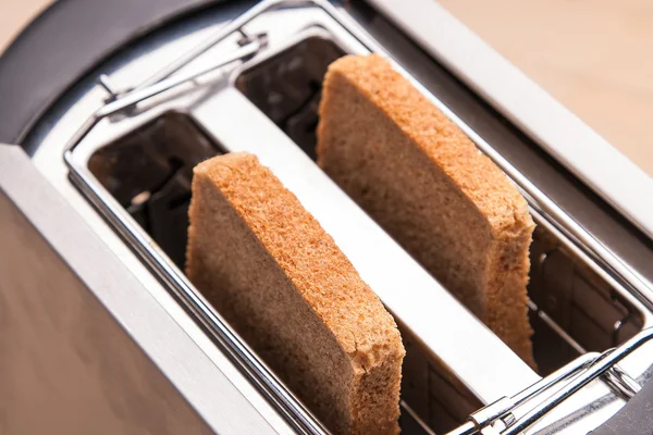 Two hot bread toast in toaster — Stock Photo, Image