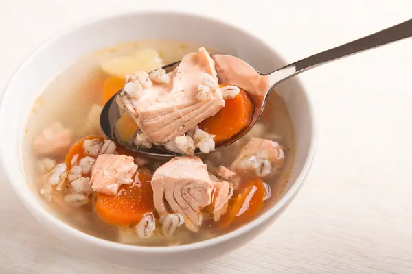 Fish soup with salmon and orge perle in spoon — Stock Photo, Image