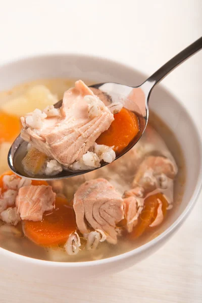 Fish soup with salmon and orge perle in spoon — Stock Photo, Image