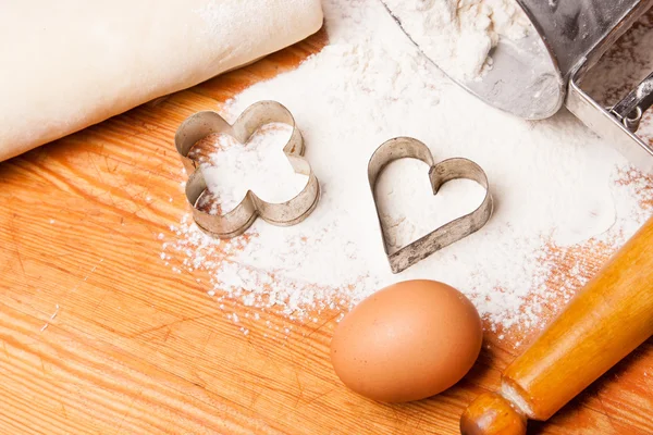 Pastry, rolling pin, eggs and figures for cookies — Stock Photo, Image