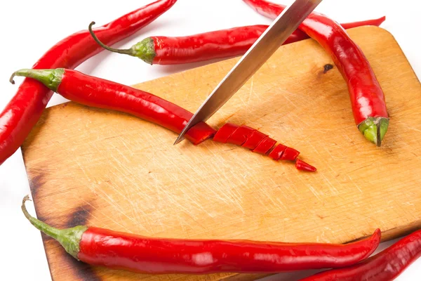 Hot capsicum chili pepper and knife on board — Stock Photo, Image