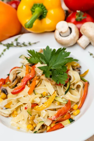 Hot pasta with garnish on plate — Stock Photo, Image