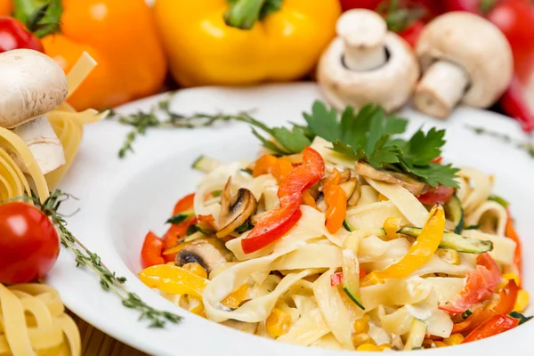 Hot pasta with garnish on plate — Stock Photo, Image