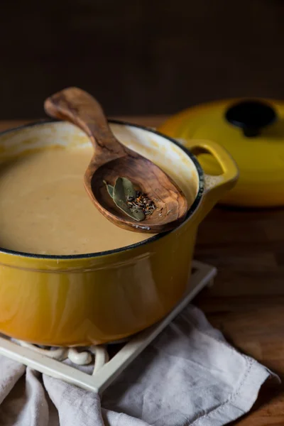 Yellow pot with hot potage soup on stand — Stock Photo, Image