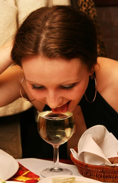 Girl drinking from a glass of wine — Stock Photo, Image