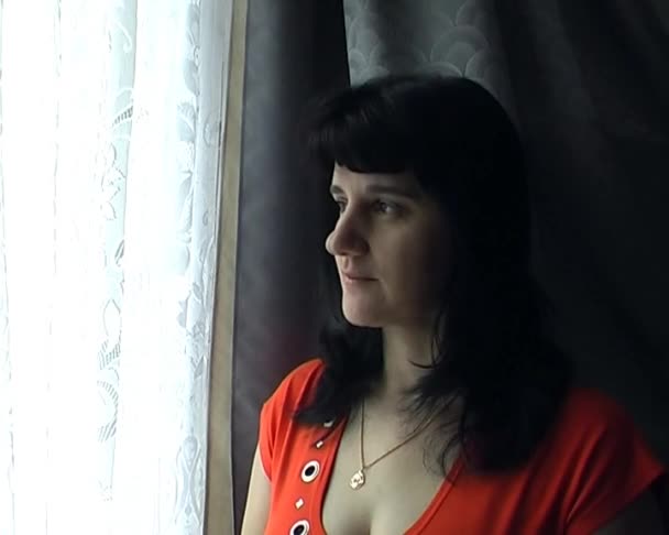 Young beautiful woman in an orange shirt — Stock Video