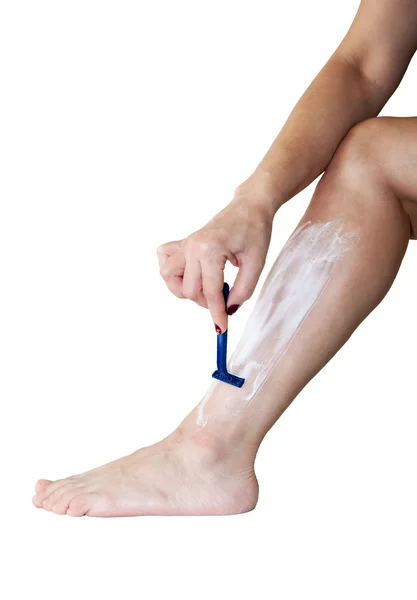 Woman shaves her leg Stock Photo