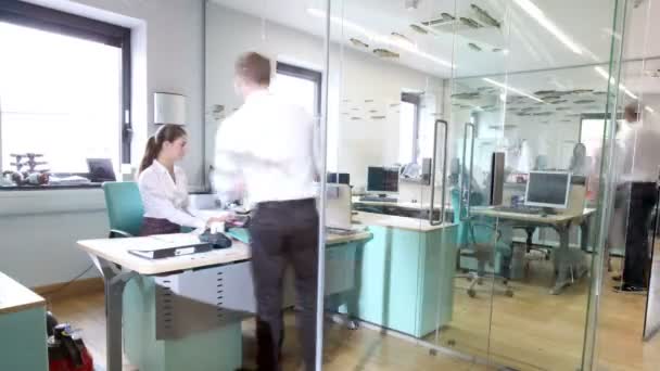 Attractive fashionable young professionals at work in busy office — Stock Video