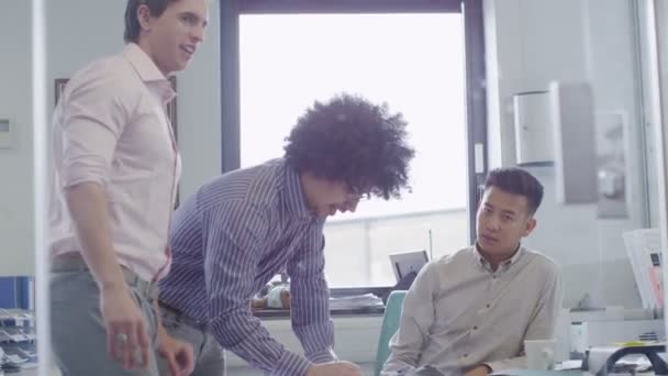 Young male business team working together in a light contemporary office — Stock Video