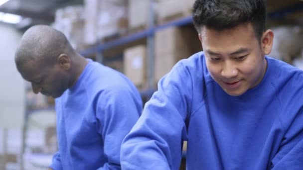 Happy male factory staff of mixed ethnicity with their line manager — Stock Video