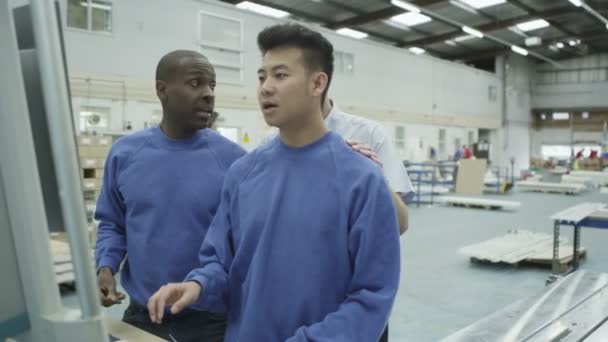 Cheerful factory or warehouse workers checking the machinery — Stock Video