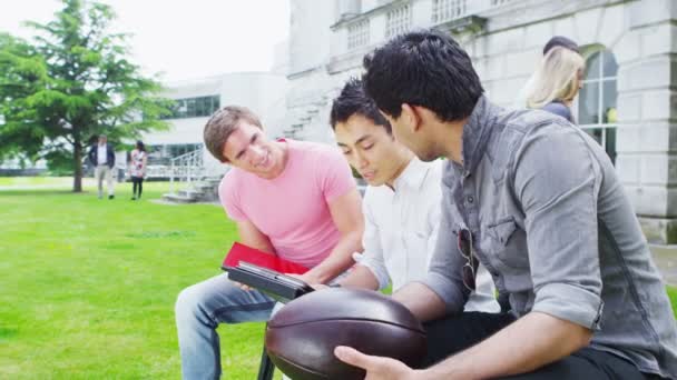 Amigos estudantes com tablet conversando juntos — Vídeo de Stock