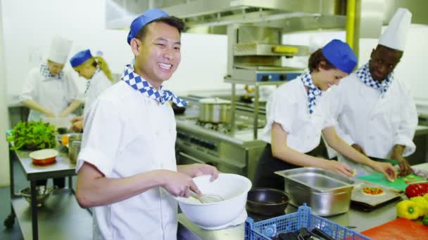 Портрет счастливого молодого работника на коммерческой кухне — стоковое видео