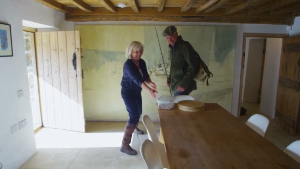 Loving wife helps husband prepare for fishing trip — Stock Video