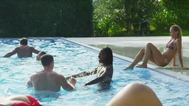 Woman lounging by pool in bikini — Stock Video