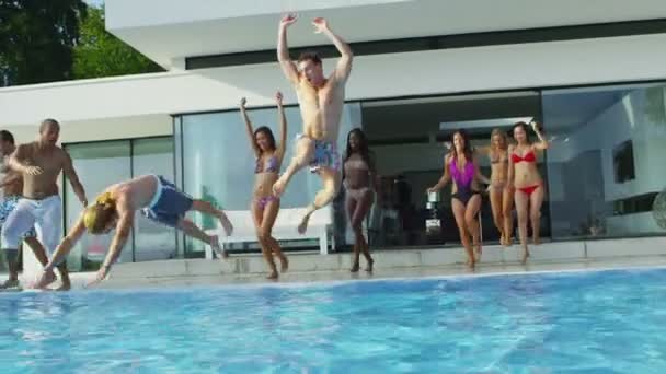 Amigos pulando e mergulhando na piscina — Vídeo de Stock