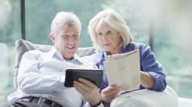 gazete ve bilgisayar tablet ile Olgun çift