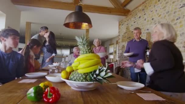 Family group sit down to enjoy meal — Stock Video