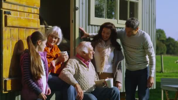 Family relaxing outside quaint caravan — Stock Video