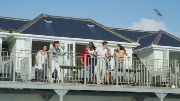 Friends on vacation go out on balcony — Stock Video