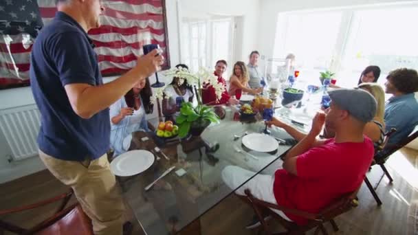 Family and friends raise their glasses for toast. — Stock Video