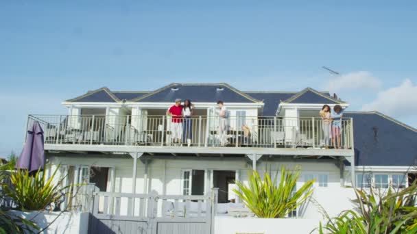 Friends on vacation go out on balcony — Stock Video