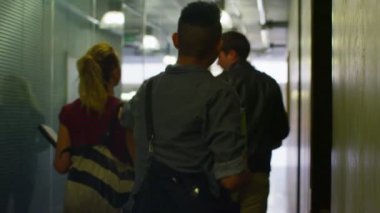 Üniversite koridorda yürürken öğrenci grubu