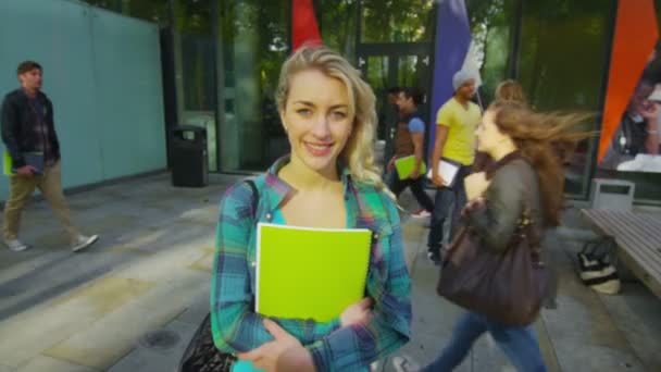 Student standing outside college building — Stock Video