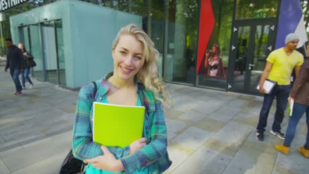 Student standing outside college building — Stock Video