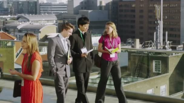 Business colleagues chat on office roof terrace — Stock Video