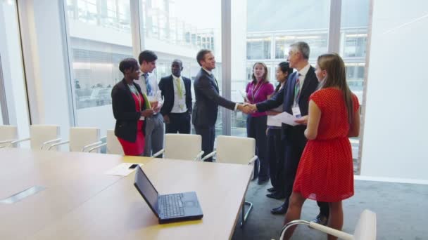 Diverse business team shake hands at the end of a boardroom meeting — Stock Video