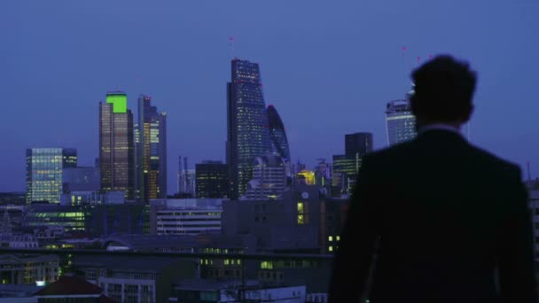 成功した実業家を見て、ロンドン市のスカイラインのビュー夜 — ストック動画