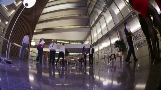 Diverse business group walking through the lobby of modern corporate building — Stock Video