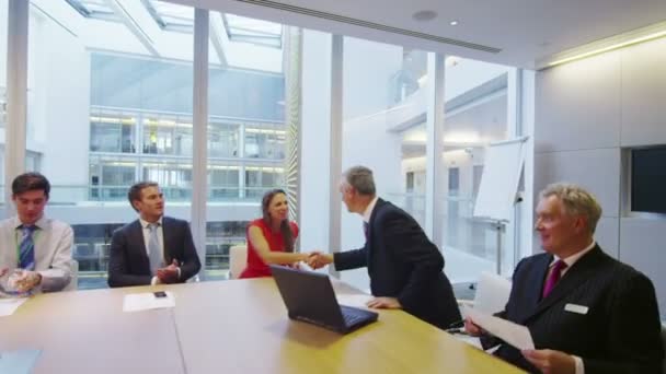 Diverse business team clap and shake hands at the end of a boardroom meeting — Stock Video
