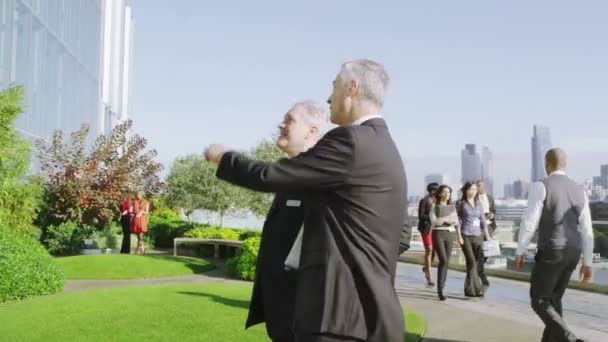 Deux hommes d'affaires se rencontrent et se serrent la main — Video