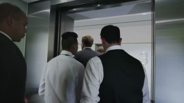 Diverse business group step out of elevator in modern office building — Stock Video