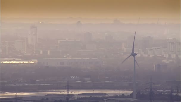 Wind turbines against smog of city — Stock Video