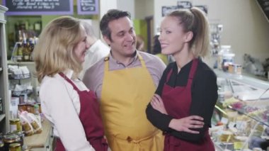 Şarküteri veya tüm gıdalar mağaza çalışanları mutlu bir ekip portresi.