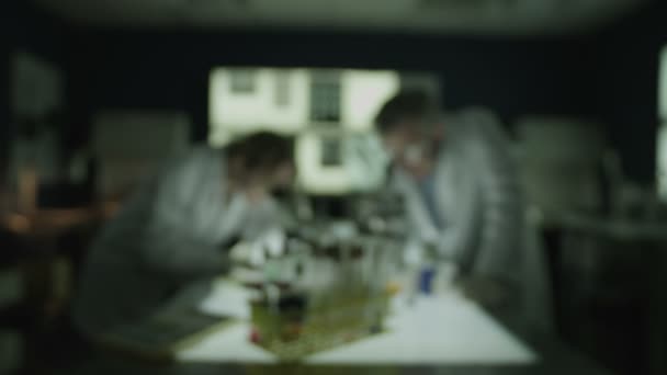 Male and female research experts working in laboratory — Stock Video