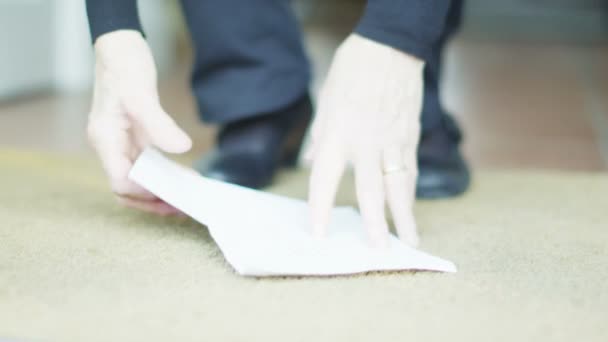 Lady bends down to pick up mail from the door mat — Stock Video