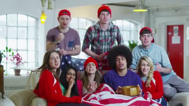 Excited group of young sports fans watching TV and spilling popcorn everywhere — Stock Video