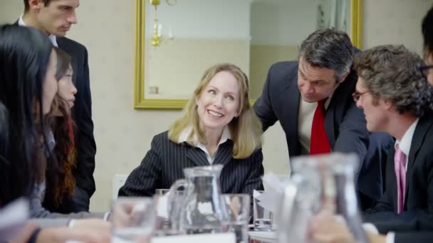 Profesionales sentados alrededor de la mesa de conferencias — Vídeos de Stock