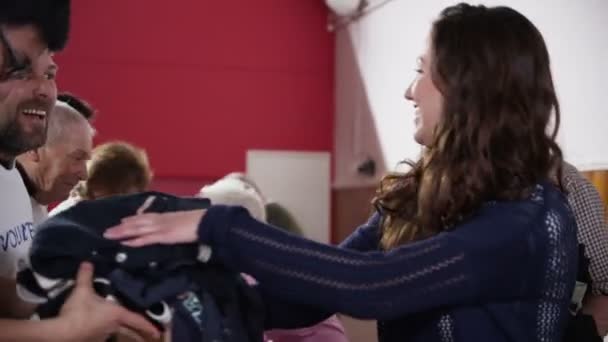 Les bénévoles acceptent les dons de nourriture et de vêtements des membres de la communauté 