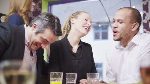 Happy group of friends or business colleagues chat together in a small cafe — Stock Video