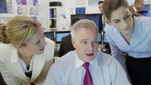 Diverse team of financial traders hard at work in a busy office — Stock Video