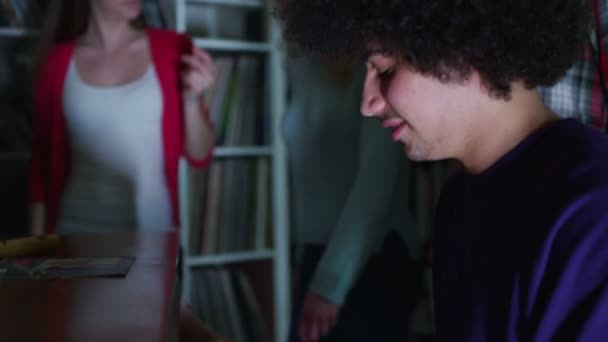 Happy and carefree group of young friends gathered around a piano at a party — Stock Video