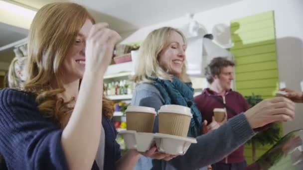 Vänliga manliga och kvinnliga baristor som betjänar kunder i ett kafépřátelské mužské a ženské baristas slouží zákazníkům v kavárně — Stockvideo