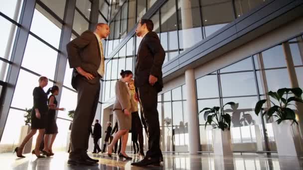 Two young businessmen meet and shake hands — Stock Video