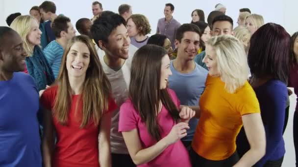 Multi ethnic group of people standing together in brightly colored casual clothing and having fun Royalty Free Stock Footage